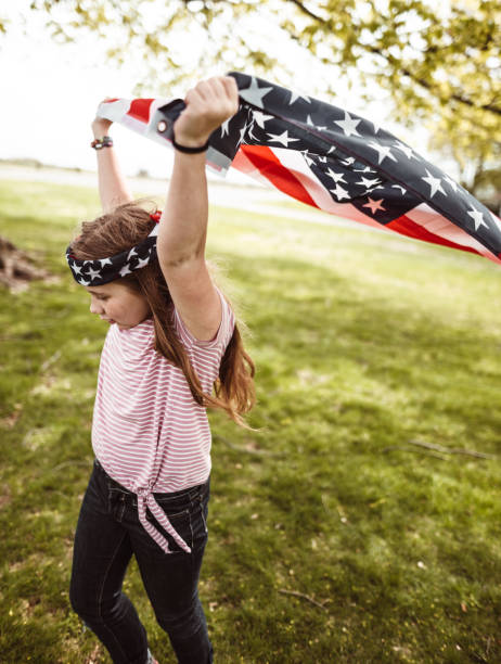 istock little kid running with us flag 1158345490