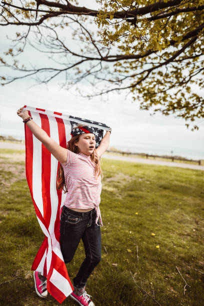 istock little kid running with us flag 1158345497