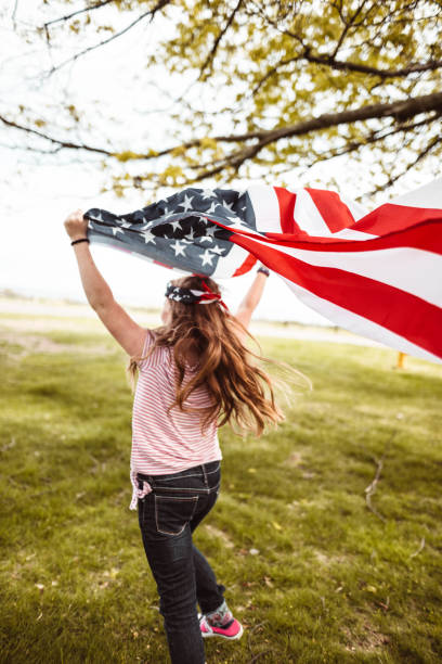 istock little kid running with us flag 1158345525