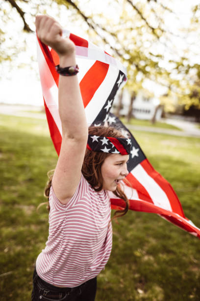istock little kid running with us flag 1158345558