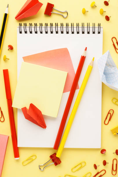 istock School notebook and various red and yellow stationery. 1158352935