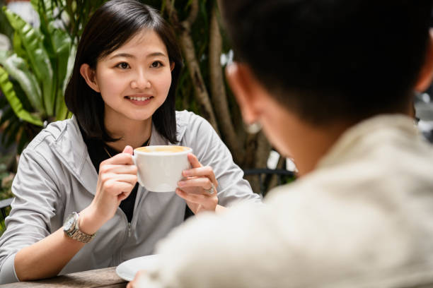 istock Woman at cafe drinking cappuccino with friend 1158352947