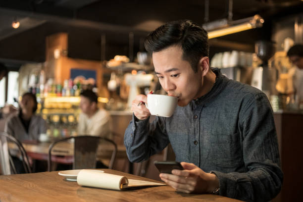 istock Freelance businessman working in cafe drinking coffee 1158352952