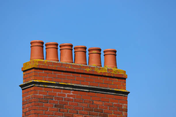 istock Victorian Chimney pots against a clear blue sky 1158352957