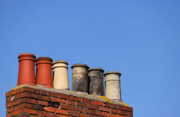 istock Victorian Chimney pots against a clear blue sky 1158352993
