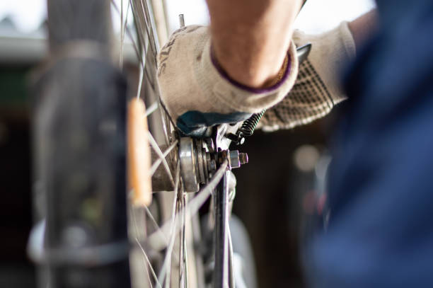 istock Hobby mechanic in overall repairs a bicycle 1158355101