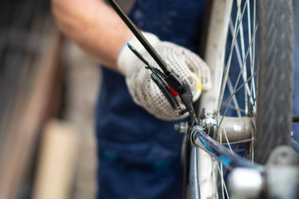 istock Hobby mechanic in overall repairs a bicycle 1158355452