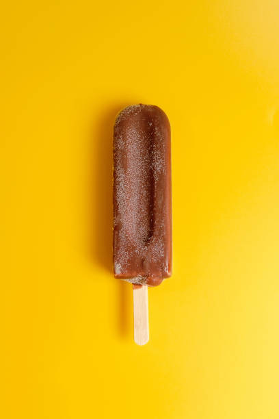 istock chocolate ice cream on yellow background 1158356140