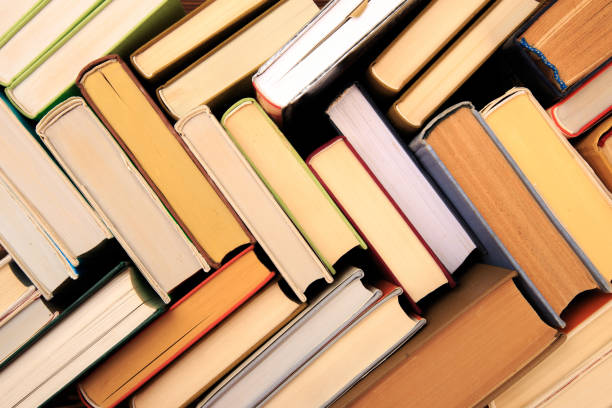 istock Many Books Piles. Hardback books on wooden table. Back to school. Copy space - Image 1158356542