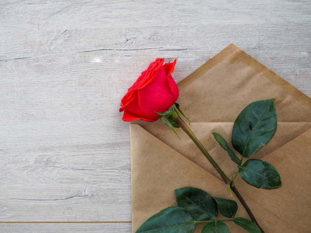 istock Red roses on wooden background 1158357493