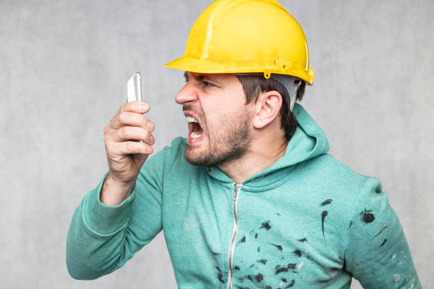 istock The building supervisor is shouting to a cell phone 1158358897