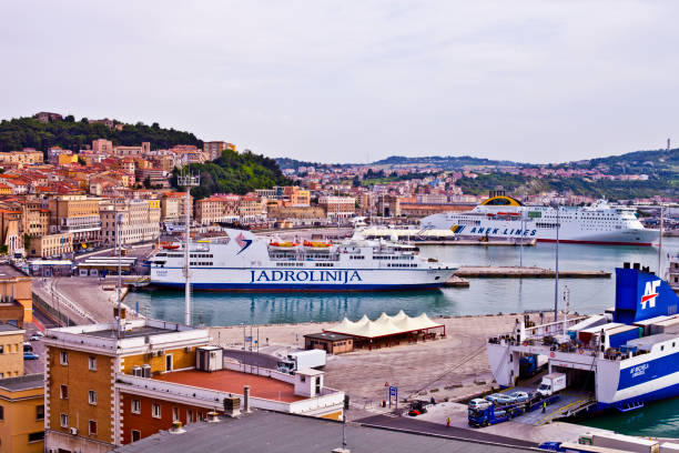 Ancona, Italy - June 8, 2019: The harbor of Ancona with cruise liner ships and boats docked and ancient city view. stock photo