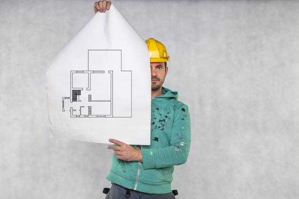 the construction worker shows the apartment plans