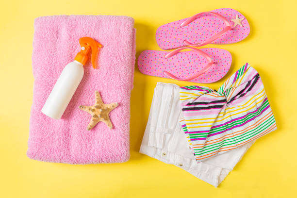 istock Flat lay composition with pink Beach accessories on yellow color background. Summer holiday background. Vacation and travel items top view 1158365063
