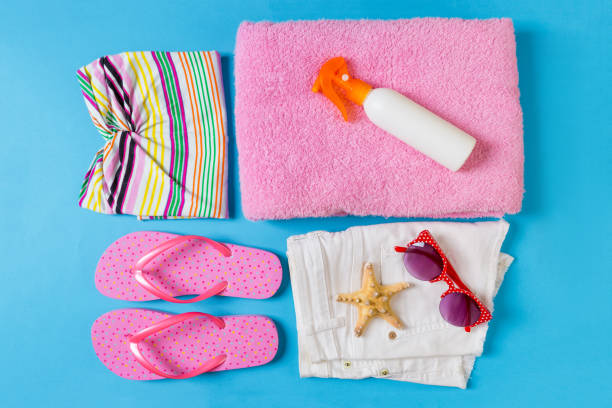 istock Flat lay composition with Beach accessories on blue color background. Summer holiday background. Vacation and travel items top view 1158365729