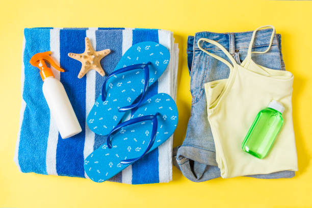 istock Flat lay composition with blue Beach accessories on yellow color background. Summer holiday background. Vacation and travel items top view 1158365953