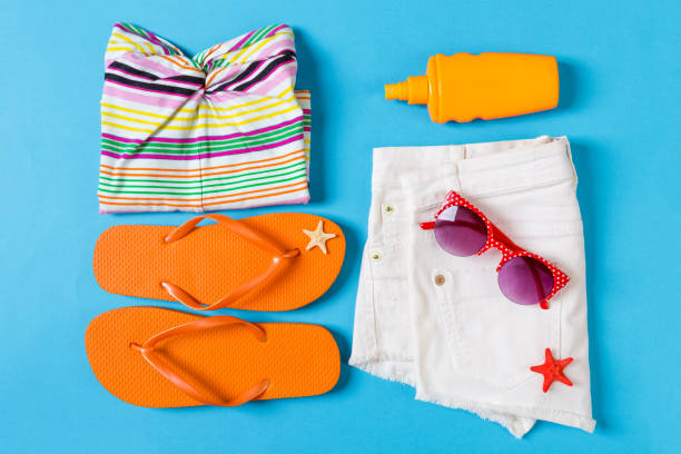 istock Flat lay composition with Beach accessories on blue color background. Summer holiday background. Vacation and travel items top view 1158366190