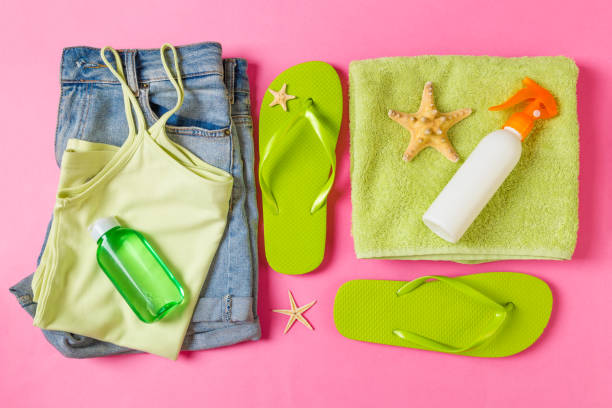 istock Flat lay composition with green Beach accessories on pink or coral color background. Summer holiday background. Vacation and travel items top view 1158366317