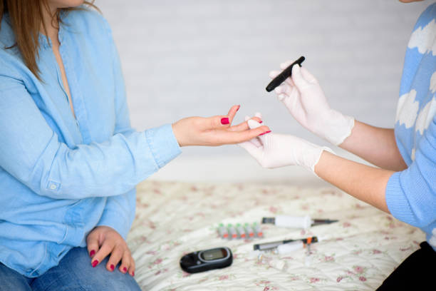 istock Doctor using lancet pen and digital glucometer to check diabetic 1158372385