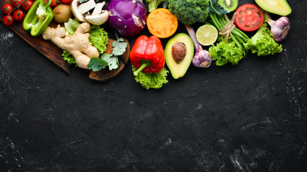 istock Fresh vegetables on a black background. Vegetarian food. Top view. Free space for your text. 1158376789