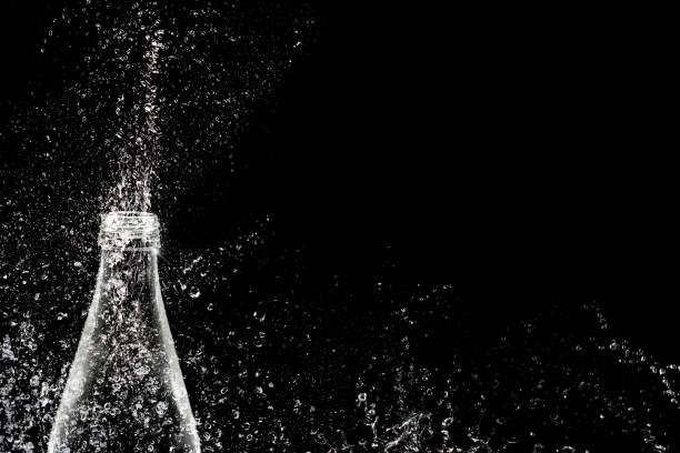 istock isolated fizzy water from bottle on black 1158381163