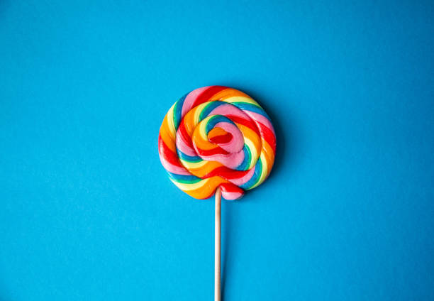istock Colorful rainbow lollipop, blue background, centered 1158381629