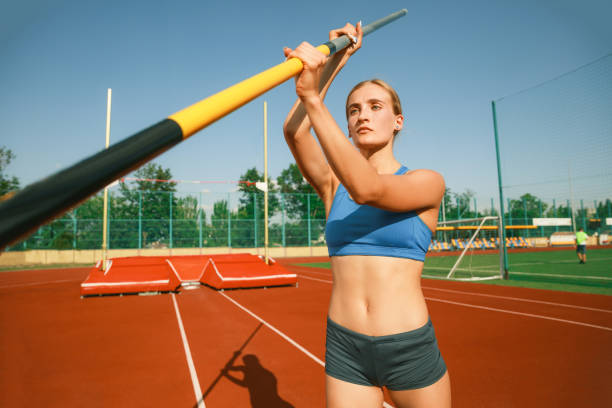 istock Female high jumper training at the stadium in sunny day 1158384436