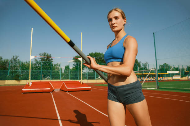 istock Female high jumper training at the stadium in sunny day 1158384457