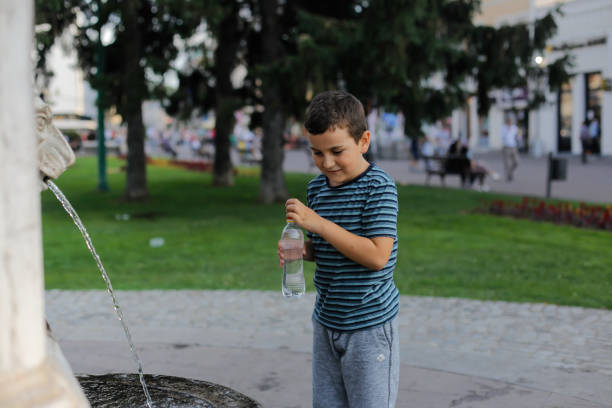 istock boy, enjoyment, fountain 1158385524