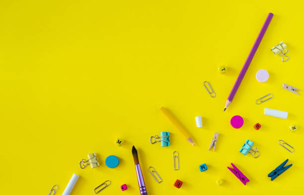 istock Multicolored school supplies on yellow background with copy space. 1158385903
