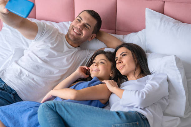 istock Happy young man taking selfie with his family 1158385973