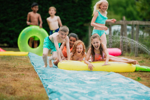 istock Playing on the Slip 'n' Slide With Friends 1158386270