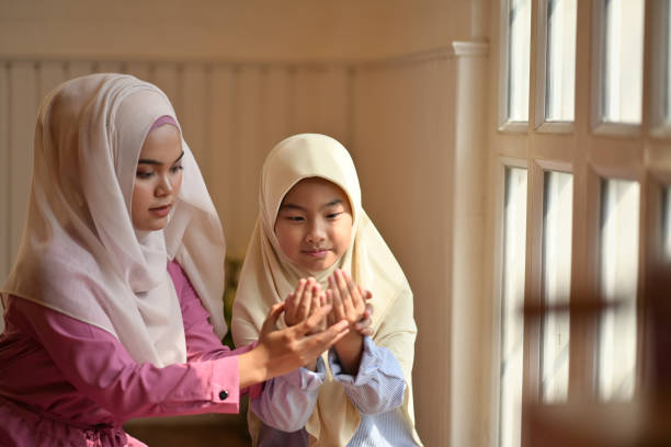 istock Muslim girl learning how to pray. 1158387912