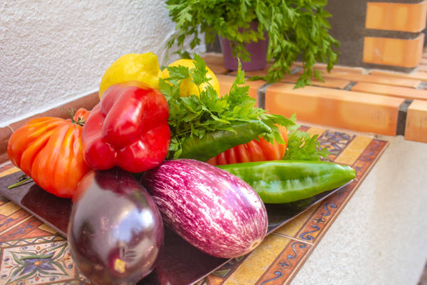 istock Assorted different bright and juicy baked vegetables, zucchini, eggplant, zucchini, tomato, pepper, onion on a dark retro background. The concept of healthy proper healthy vegan food. View from above 1158388954