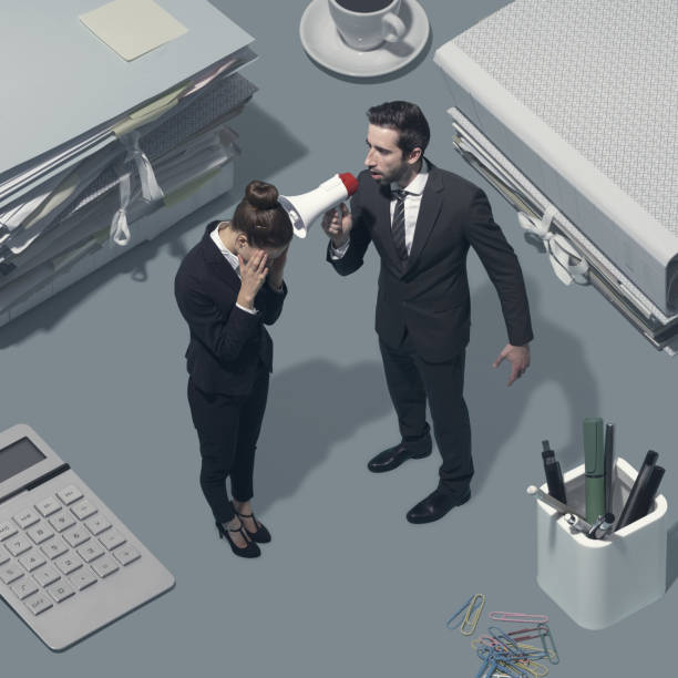 istock Boss shouting at his employee with a megaphone 1158389072