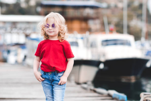 istock Stylish kid girl over sea 1158389300
