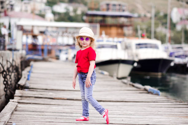 istock Stylish kid girl over sea 1158389327