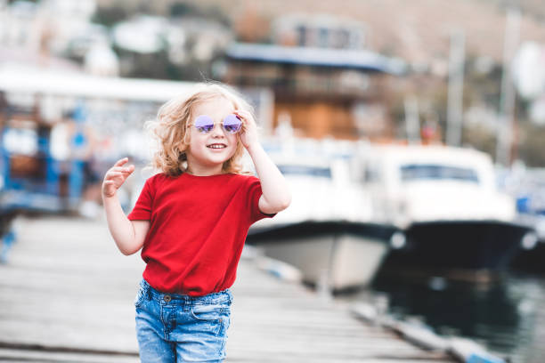 istock Stylish kid girl over sea 1158389370