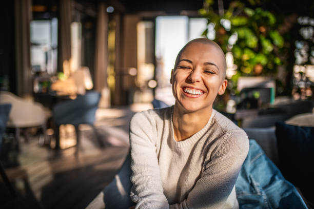 Portrait of a smiling girl with short hair Portrait of a smiling girl with short laughing with her eyes closed bald teenage girl stock pictures, royalty-free photos & images