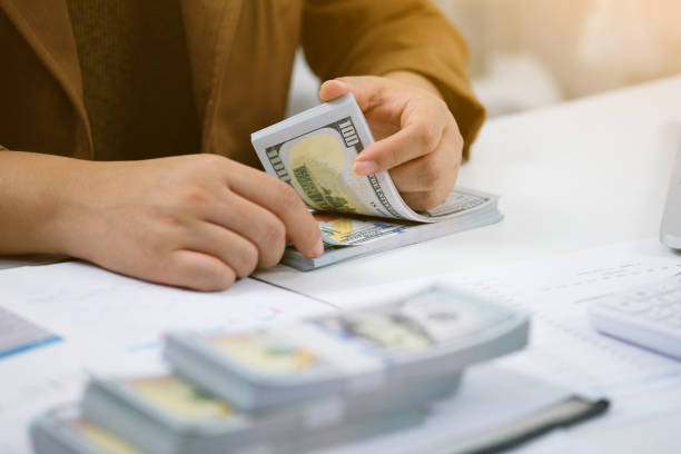 istock Businessman analyzing investment charts and pressing calculator buttons over documents. Accounting Concept. 1158391029