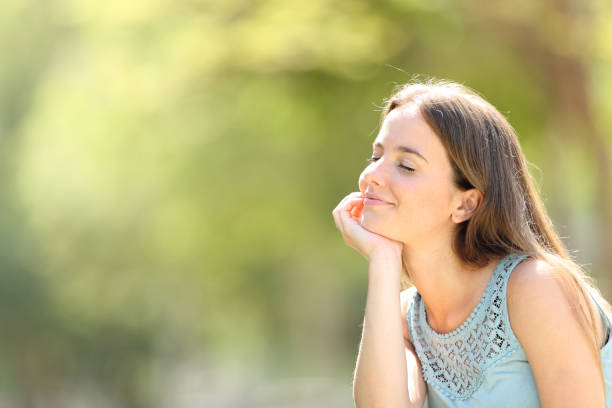 istock Smiley woman meditating and relaxing in a forest 1158391251