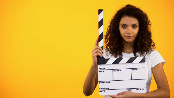Beautiful afro-american woman holding clapper board, movie shooting, audition Beautiful afro-american woman holding clapper board, movie shooting, audition audition photos stock pictures, royalty-free photos & images
