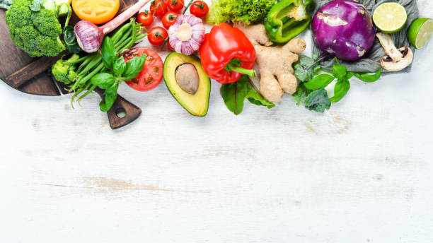 istock Fresh raw vegetables on a white background Wooden. Top view. Free space for your text. 1158392710