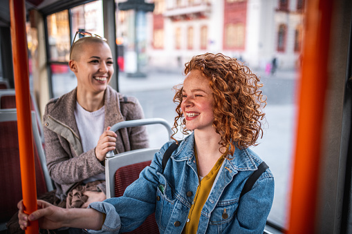 Two female friends traveling with the bus. They are laughing