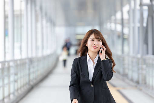 Business woman walking while calling
