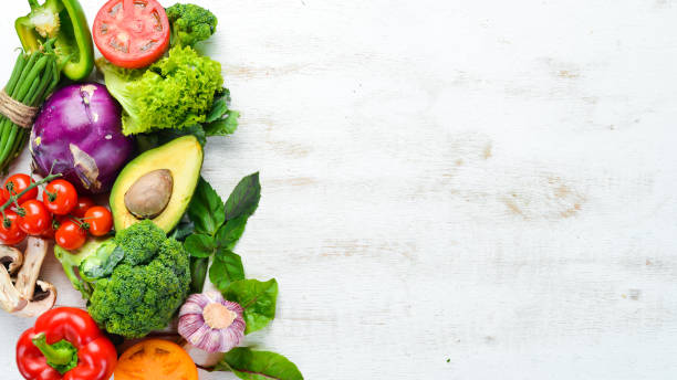 istock Fresh raw vegetables on a white background Wooden. Top view. Free space for your text. 1158392822