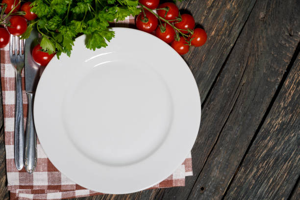 istock table setting with white plate and vegetables on wooden table 1158393832