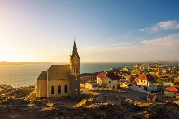 Luderitz in Namibia with lutheran church called Felsenkirche at sunset stock photo