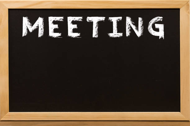 istock Meeting word write by white chalk on a blackboard. 1158395944