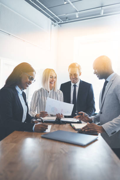istock Diverse group of smiling businesspeople working around an office table 1158396084